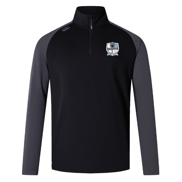 The Austin Huns Rugby Women's Elite First Layer by EMB Canterbury is a black and gray long-sleeve quarter-zip pullover with VapoDri moisture-wicking technology, a crest logo on the left chest, and an EMB Canterbury logo on the right shoulder.