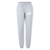 The EMB Canterbury Clarksville Headhunters Women's Leisure Sweatpant features light grey organic cotton, elastic cuffs, and two white logos near the waistband—combining comfort and style for everyday wear.