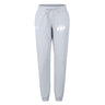 The EMB Canterbury Clarksville Headhunters Women's Leisure Sweatpant features light grey organic cotton, elastic cuffs, and two white logos near the waistband—combining comfort and style for everyday wear.