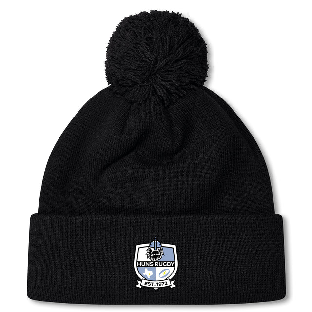 Stay warm in the Austin Huns Rugby Pom Pom Beanie by Canterbury, fleece-lined for extra comfort and featuring a "Huns Rugby Est. 1972" embroidered patch on the front cuff. Brand: EMB Canterbury.