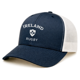 Show your pride with the Nations of Rugby Ireland Retro Trucker Cap by EMB S&S Activewear, a navy blue and white mesh hat featuring "Ireland Rugby" and a shamrock crest embroidered on the front.
