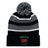 The EMB Augusta Nations of Rugby Wales Hooped Knit Fold Over Pom-Pom Beanie features black, grey, and white stripes, "WALES RUGBY" text, a pom-pom top, and an embroidered red dragon logo on the front.