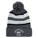 The EMB Augusta Nations of Rugby New Zealand Hooped Pom-Pom Beanie features gray, black, and white stripes, a playful top pom-pom, and "New Zealand Rugby" with a silver fern embroidered on the cuff—perfect for any rugby fan.
