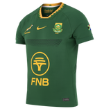 The Springboks 26/27 Authentic Match Home Jersey by Nike is a green rugby shirt with yellow accents, official team and Springbok logos, FNB sponsor, South African flag on the sleeve—a must-have for true fans.