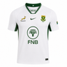 The Springboks 26/27 Replica Away Jersey by Nike is a white South Africa rugby jersey with green accents, featuring the Springbok logo, Rugby badge, FNB sponsor, Nike logo, and a small South African flag on the sleeve.