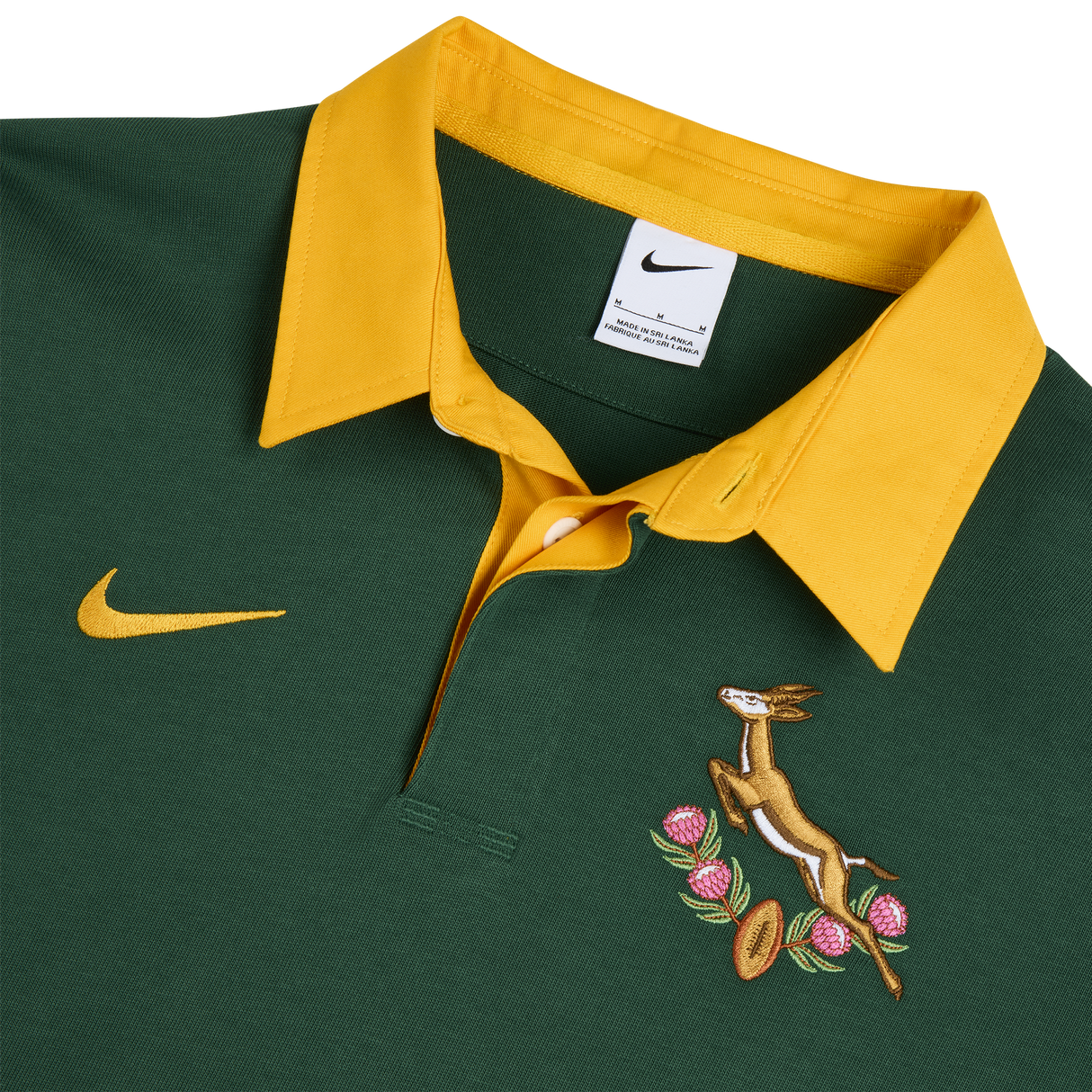 The Nike Springboks Home Long Sleeve Rugby Shirt features classic green and gold colors, a yellow collar, and embroidered springbok and protea emblems—perfect for any South African rugby fan.