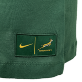 Close-up of the Women's Springboks 25 Bokke T-Shirt by Nike in green, featuring the iconic logo and Springboks emblem, with yellow text and hem stitching. A must-have for any BOKKE fan or as a stylish Nike women’s tee.
