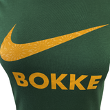 The Women's Springboks 25 Bokke T-Shirt by Nike is a green tee with a yellow Nike swoosh above "BOKKE" in bold yellow letters.