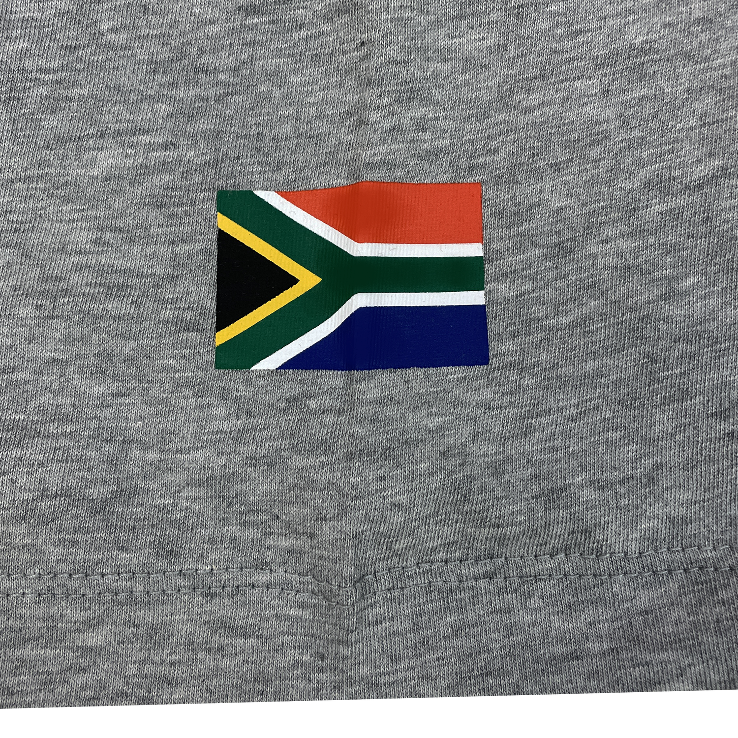 The Springboks 25 Heritage GPX T-Shirt by Nike features a small South African flag on grey fabric, honoring the spirit of the Springboks rugby team.