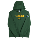 The Nike Springboks Bokke Pullover Hoodie features a green design, bold yellow "BOKKE" on the chest, a South African flag patch on the left sleeve, and classic Springboks style.