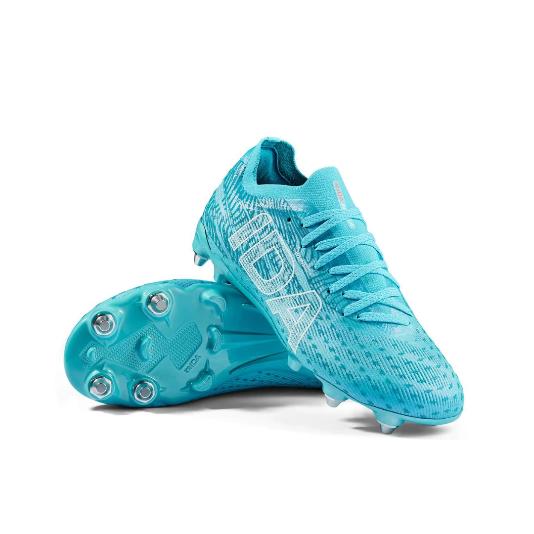A pair of IDA Sports Ida Women's Helia Pro SG - Blue cleats, one upright and one showing the metal-studded sole, designed with laces for lightweight performance on wet and muddy fields.