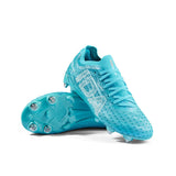 A pair of IDA Sports Ida Women's Helia Pro SG - Blue cleats, one upright and one showing the metal-studded sole, designed with laces for lightweight performance on wet and muddy fields.
