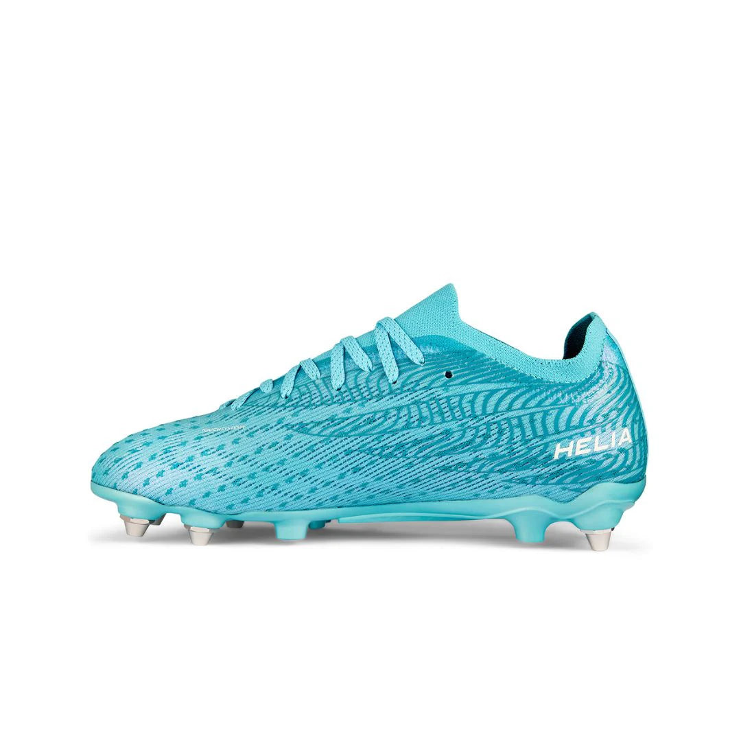 The IDA Sports Ida Women's Helia Pro SG - Blue is a turquoise soccer cleat for women, featuring white studs, a patterned design, and "Helia" near the heel, offering lightweight performance ideal for wet and muddy fields.