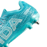 A close-up of the IDA Sports Ida Women's Helia Pro SG - Blue soccer cleat, showing metal-tipped studs for lightweight play on wet fields and a textured upper.