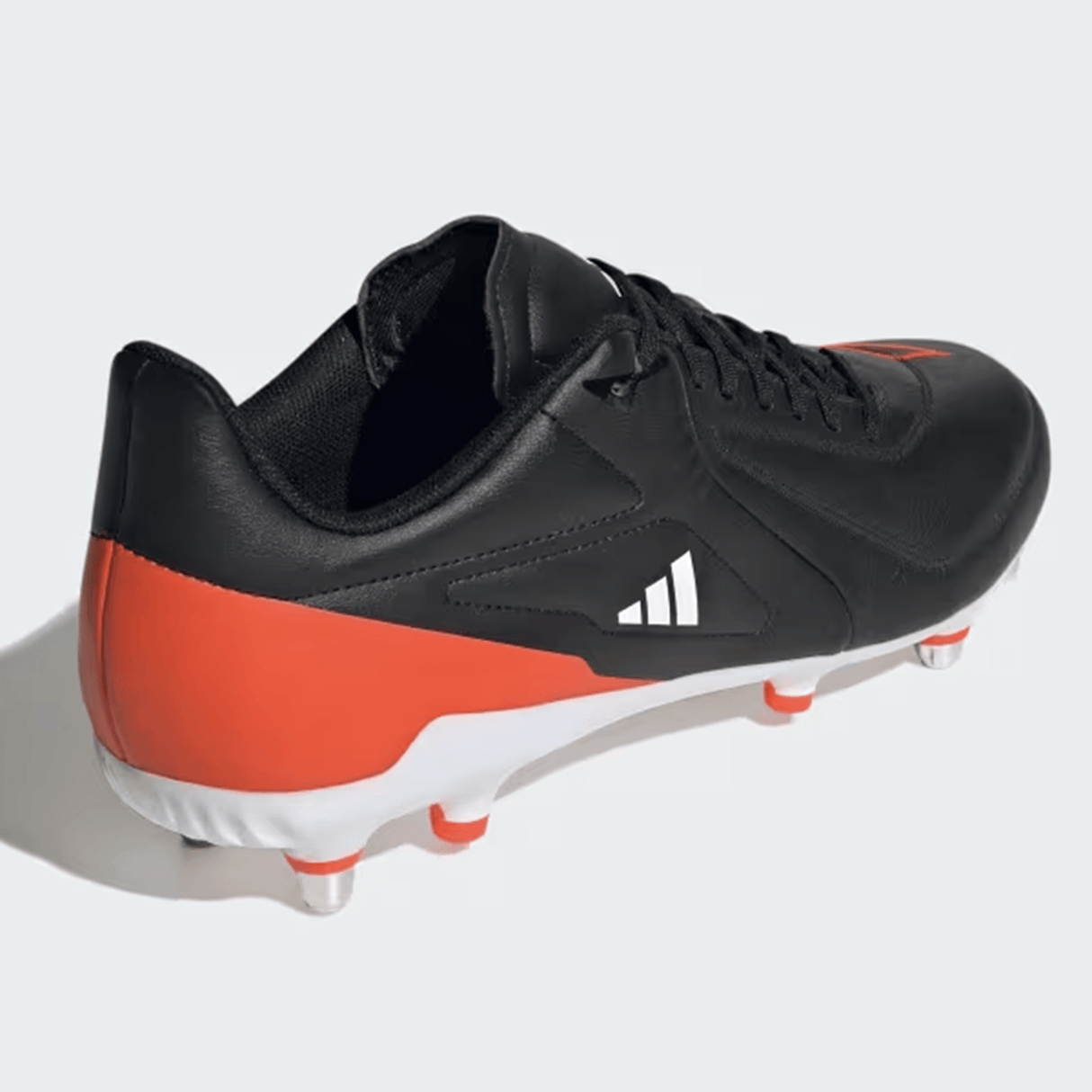 A Core Black and Solar Red adidas RS15 Elite SG 24 soccer cleat from adidas, featuring white studs and a white Adidas logo on the side, displayed from a rear-side angle.