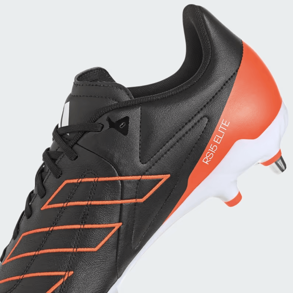 Core Black/Core Black/Solar Red leather boots featuring "RS15 ELITE" on the heel and metal studs on the sole, ideal as soft ground rugby cleats.