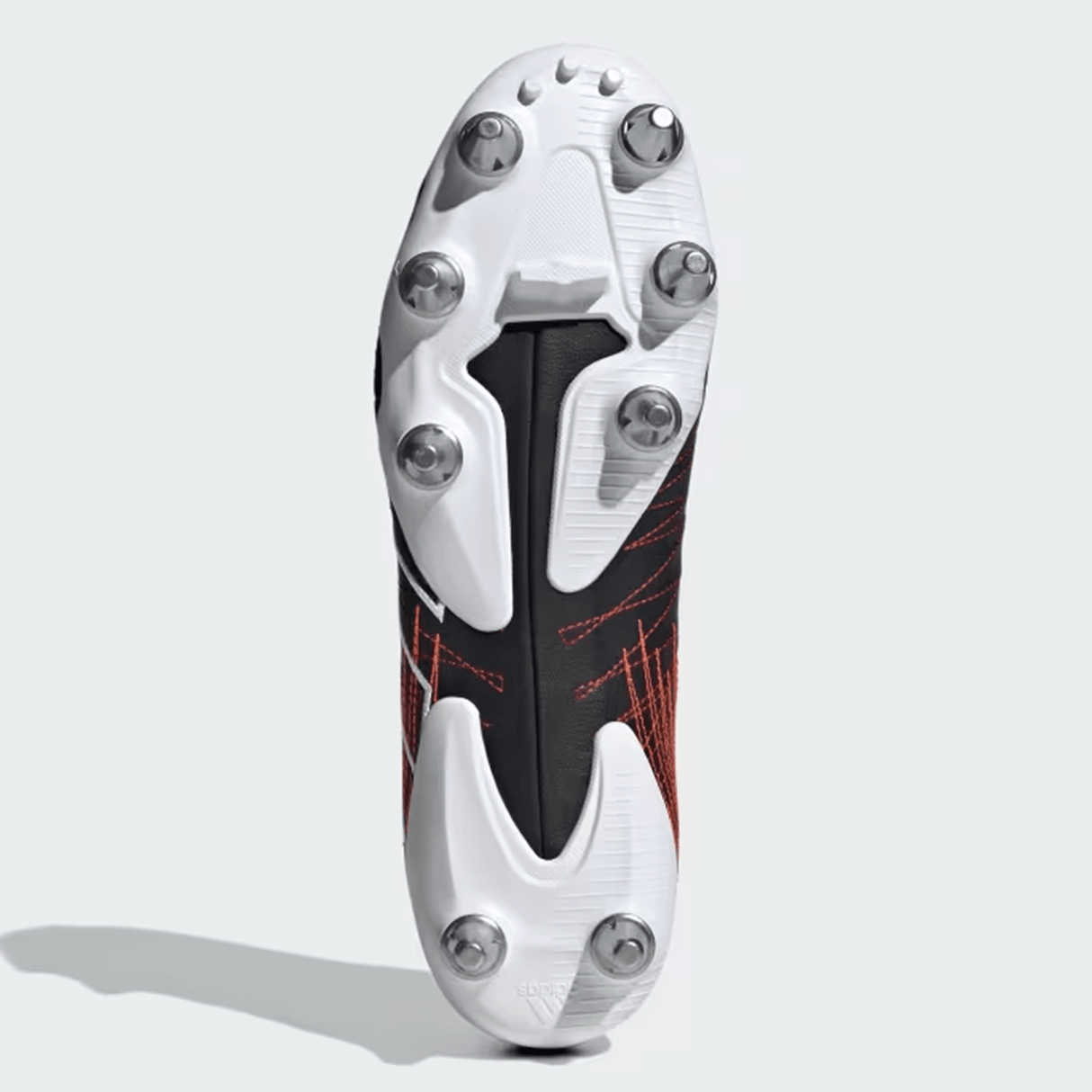 A solitary Core Black/Core Black/Better Scarlet adidas Kakari Elite SG 24, a lightweight rugby boot with metal studs for soft ground, is shown from the bottom view against a plain white background.