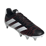 The adidas Kakari SG in Core Black/White/Better Scarlet is a black soccer cleat with red accents, featuring white stripes and metal studs for optimal grip on soft ground. Made from recycled materials, it is showcased on a white background.
