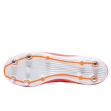 The image showcases the underside of adidas' RS15 Elite SG rugby boots, featuring metal studs with an orange trim on a white sole, enhanced with foam cushioning for optimal comfort.