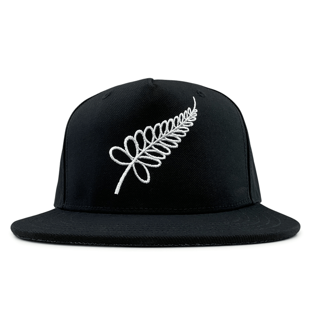 An All Blacks Snapback Cap by adidas, featuring a black design with a white embroidered fern on the front, showcasing New Zealand pride.