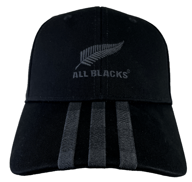 This Adidas All Blacks 3-Stripe Cap, crafted from black cotton twill, showcases the iconic All Blacks logo and a silver fern emblem on the front, complemented by three vertical gray stripes below the logo.
