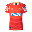 The Dolphins NRL 25/26 Replica Home Jersey by Classic Sportswear showcases a red and orange design with the iconic "KINGS" logo, a striking dolphin graphic, and white sponsor names on the sleeves, proudly embodying the Dolphins NRL spirit.