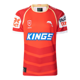 The Dolphins NRL 25/26 Replica Home Jersey by Classic Sportswear showcases a red and orange design with the iconic "KINGS" logo, a striking dolphin graphic, and white sponsor names on the sleeves, proudly embodying the Dolphins NRL spirit.