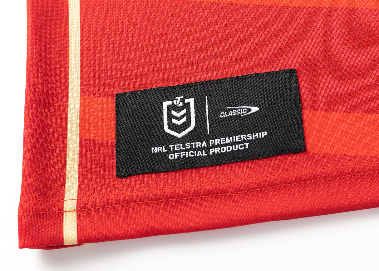 Close-up of a red Dolphins NRL 25/26 Replica Home Jersey by Classic Sportswear, featuring the "NRL Telstra Premiership Official Product" logo on a black rectangular patch.
