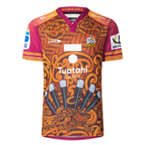 The Gallagher Chiefs Super Rugby Replica Training Jersey 25/26 by Classic Sportswear features brown and orange patterns, a "Chiefs" logo, sponsor logos, stylized feathers, and tribal designs—ideal for fans who love tradition and style.