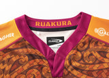 A close-up of the maroon and orange Gallagher Chiefs Super Rugby Replica Training Jersey 25/26 by Classic Sportswear, adorned with decorative patterns. The inside collar reads "RUAKURA," and labels are attached, making it perfect for fans to display their support.
