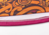 A close-up of the Gallagher Chiefs Super Rugby Replica Training Jersey 25/26 by Classic Sportswear showcases the intricate orange and brown pattern with a red border, highlighted against a white background, reflecting team spirit and craftsmanship.