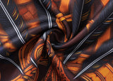 Close-up of the Gallagher Chiefs Super Rugby Replica Training Jersey 25/26 by Classic Sportswear, showcasing richly patterned fabric in orange and black with intricate geometric shapes and a classic sportswear aesthetic.
