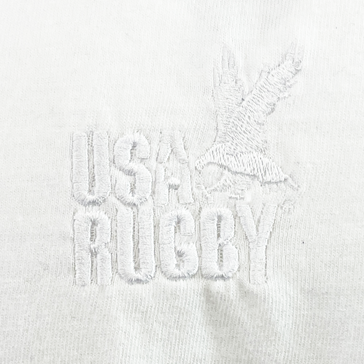 The USA Rugby Elevated Throwback Tonal Comfort Tee by EMB Alpha Broder features a white embroidered eagle and "USA Rugby" on premium ring-spun USA cotton, set on a white background.