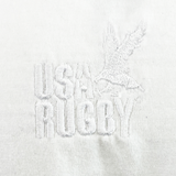 The USA Rugby Elevated Throwback Tonal Comfort Tee by EMB Alpha Broder features a white embroidered eagle and "USA Rugby" on premium ring-spun USA cotton, set on a white background.