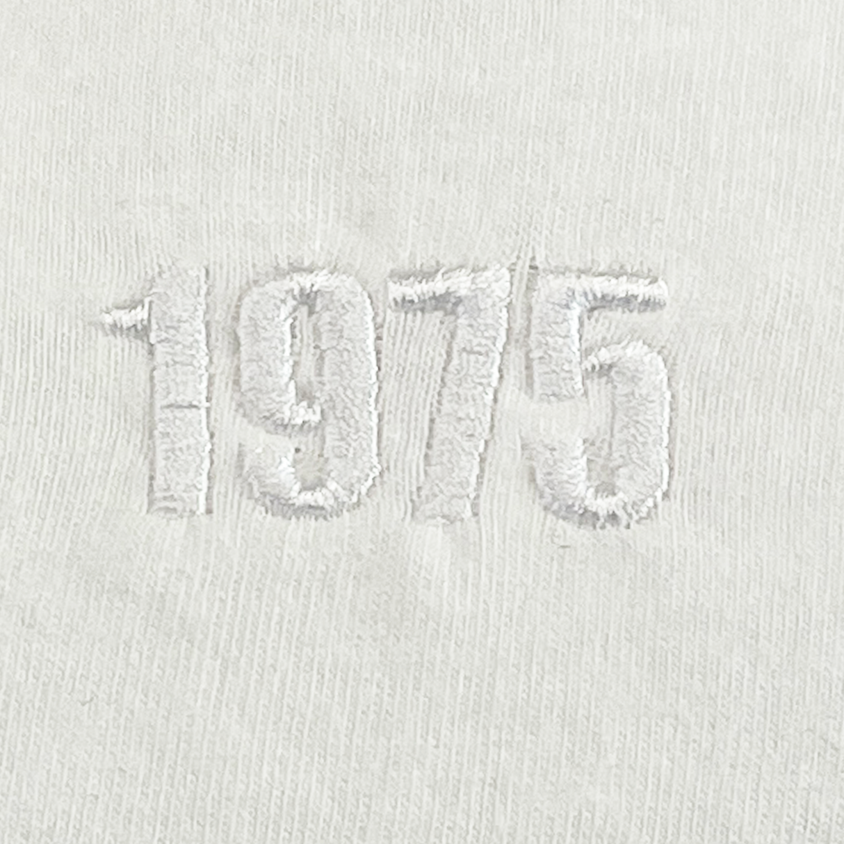 The USA Rugby Elevated Tonal Comfort Tee by EMB Alpha Broder showcases a tone-on-tone design with "1975" beautifully embroidered in white thread on premium ring-spun USA cotton.