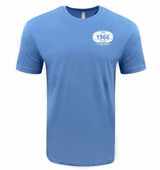 The UNC 1966 Club Tee by EMB LAT is a light blue short-sleeve shirt with a small white oval logo on the left chest reading "THE 1966 CLUB UK PROFESSIONAL"—ideal for Tar Heel rugby fans and lovers of classic club tee style.