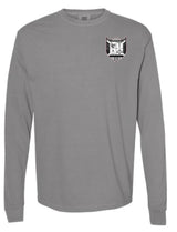 The Troy Rugby Long Sleeve Comfort Tee by EMB S&S Activewear is a gray shirt with a black and white shield emblem featuring embroidered symbols and letters on the left chest.