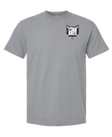 The Troy Rugby Comfort Tee by EMB S&S Activewear is a gray short-sleeve shirt crafted from ring-spun USA cotton, featuring a black and white shield emblem with letters and symbols on the upper left chest.