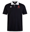 The Archbishop Spalding Solid Classic SS Rugby Jersey by EMB Canterbury is a black short-sleeved polo featuring a white collar, Canterbury branding on the right chest, and a red embroidered "SA" with crossed swords on the left.