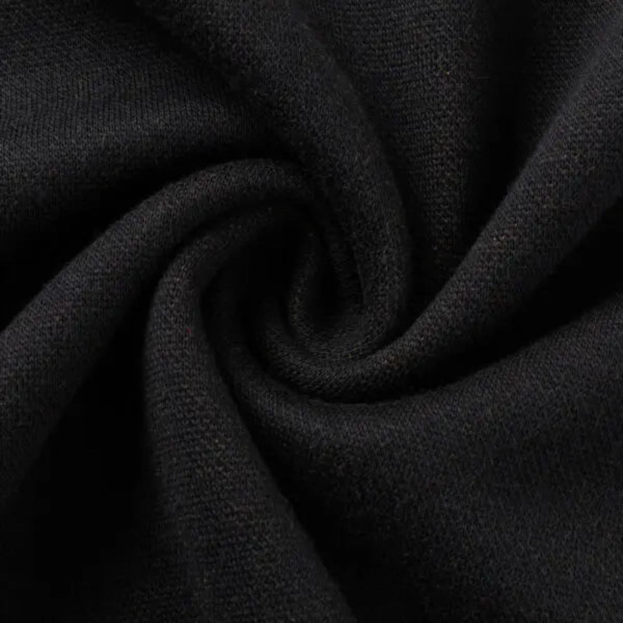 Close-up of black fabric with a spiral twist pattern, reminiscent of the Limited Edition Gallagher Chiefs Super Rugby 25/26 Retro Jersey by Classic Sportswear.