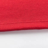 A close-up of a red fabric edge on a white background highlights detailed stitching characteristic of Classic Sportswear's Limited Edition Crusaders Super Rugby 25/26 Retro Jersey craftsmanship.
