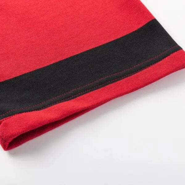 Close-up of a red fabric edge featuring a black stripe and visible stitching, reminiscent of the Limited Edition Crusaders Super Rugby 25/26 Retro Jersey by Classic Sportswear.