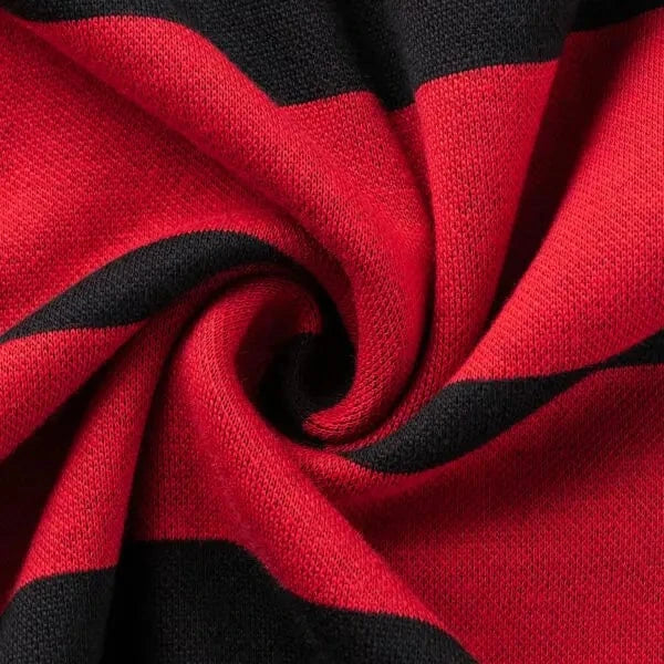 A close-up of the red and black striped heavyweight cotton fabric of the Limited Edition Crusaders Super Rugby 25/26 Retro Jersey by Classic Sportswear, twisted into a spiral pattern.