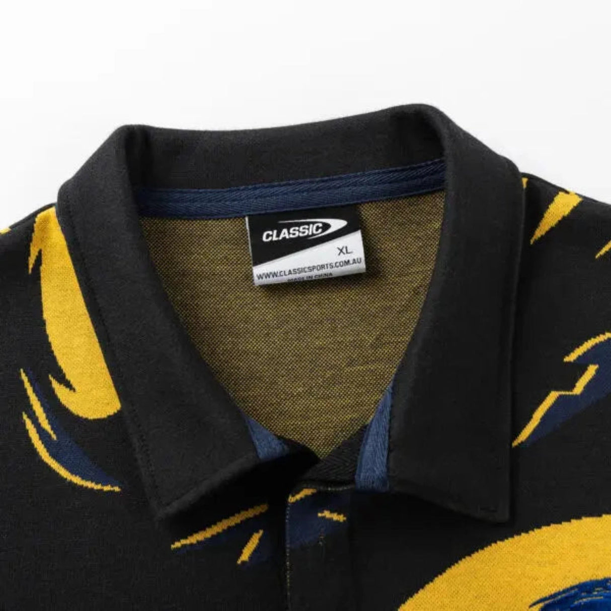 Close-up of the Hurricanes Super Rugby 25/26 Retro Jersey collar by Classic Sportswear, featuring a bold yellow and blue pattern. The label displays "Classic Sportswear" with a website link and size XL.