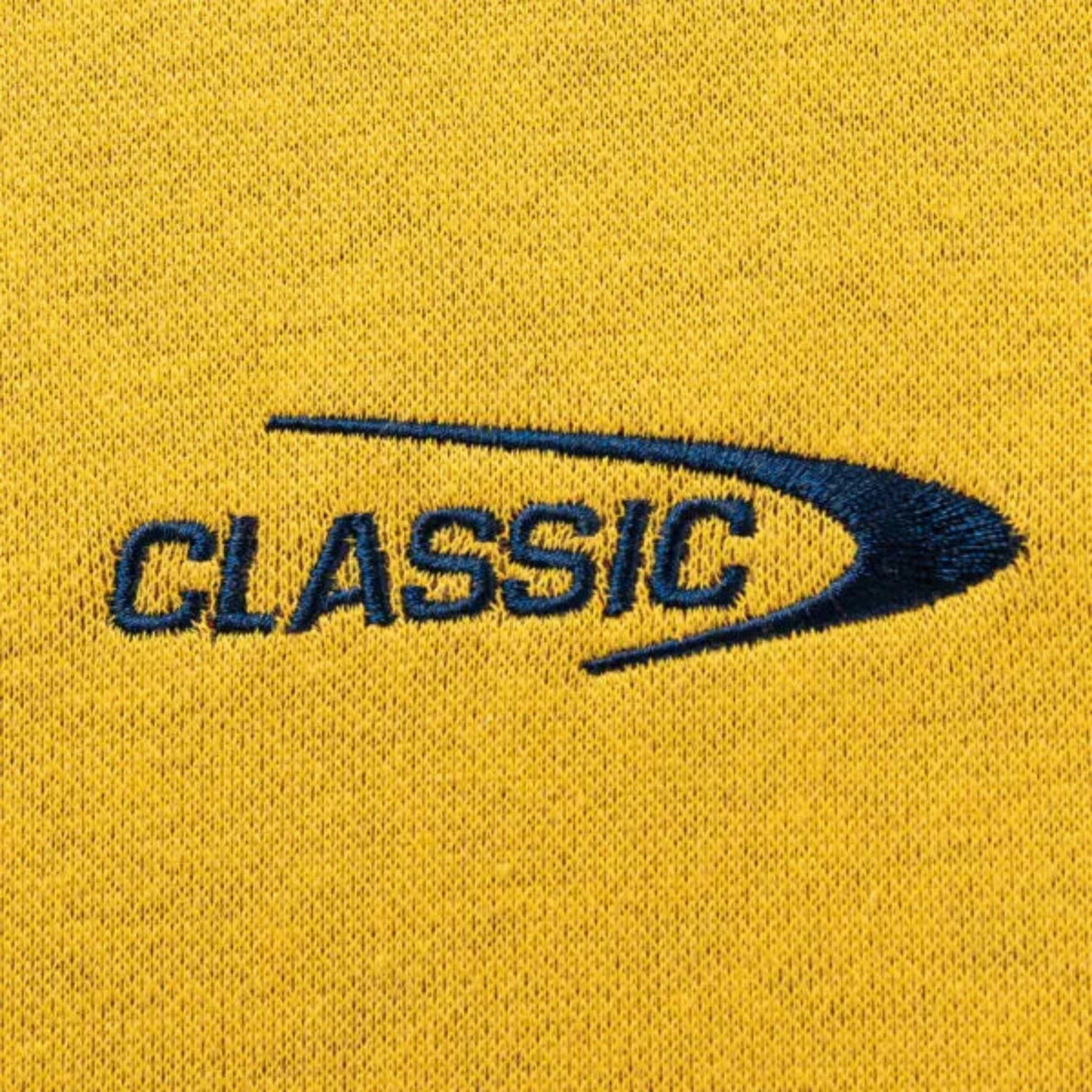 A yellow fabric features "CLASSIC" in blue and a curved line, evoking the Limited Edition Highlanders Super Rugby 25/26 Retro Jersey by Classic Sportswear.
