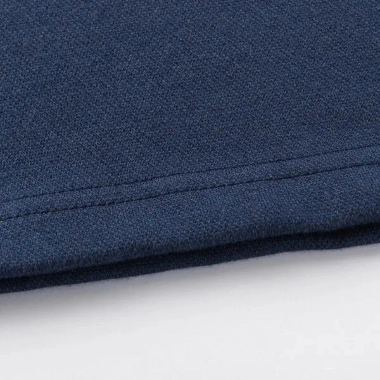 Close-up of the Limited Edition Highlanders Super Rugby 25/26 Retro Jersey by Classic Sportswear's hem in dark blue, highlighting its texture and stitching—a nod to classic sportswear.