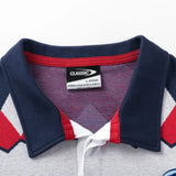 A close-up of a collared shirt showcases a navy blue, white, and red chevron pattern, reminiscent of classic sportswear. The label reads "Limited Edition Blues Super Rugby 25/26 Retro Jersey by Classic Sportswear," exuding the vibe of a retro jersey.