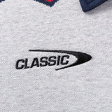 Close-up of gray fabric with "CLASSIC" and a curved design embroidered in black, reflecting the style of the Limited Edition Blues Super Rugby 25/26 Retro Jersey by Classic Sportswear.