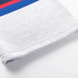 A close-up of the Limited Edition Blues Super Rugby 25/26 Retro Jersey by Classic Sportswear shows a gray fabric with red and blue stripes at the top edge, evoking a nostalgic jersey style.