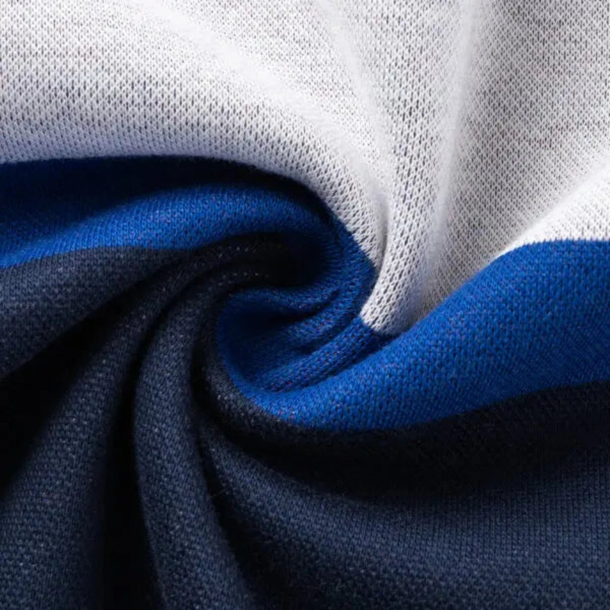 A close-up of the Limited Edition Blues Super Rugby 25/26 Retro Jersey by Classic Sportswear shows twisted folds in white, blue, and black.